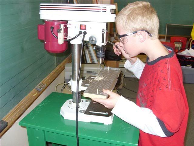 Student at the drill press