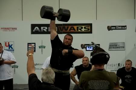 Terry Hollands gets a thumbs-up from Geoff Capes on dumbbell press