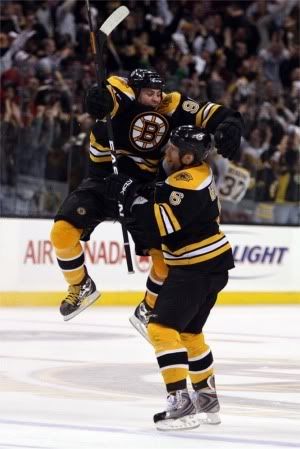 Marc Savard jumps into the waiting arms of the guy the Blues traded for Bradley Boyes.