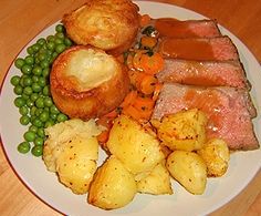 Roast beef with Yorkshire puddings, roast potatoes and vegetables
